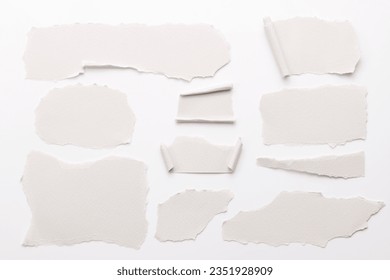 Art collage of pieces of ripped paper with torn edges. Sticky notes collection white colors, shreds of notebook pages. Abstract background