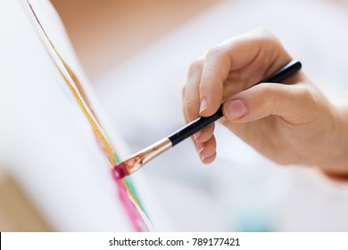 art, creativity and people concept - hand of artist with brush painting picture - Shutterstock ID 789177421