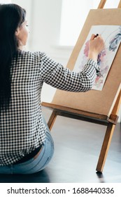 Art, creativity, professional occupation. Artist at work in home studio. Woman painting with watercolor at easel. Creative leisure concept - Shutterstock ID 1688440336