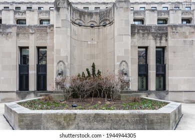 Art Deco Exterior Design With Sculptures And Barren Garden In Urban Chicago On Overcast Day