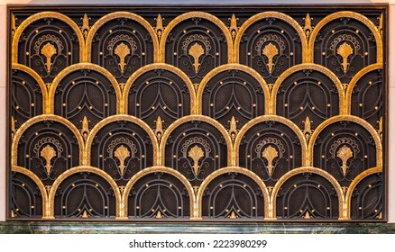 Art deco style European door with gold colored fish scale ornaments, architectural detail from Madrid, Spain