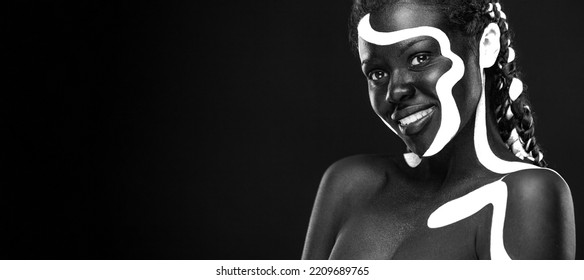 The Art Face. Black And White Body Paint On African Woman. Abstract Creative Portrait. Bright Fashion Makeup On The Girl.