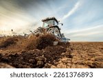 The art of farming, tractor tilling the soil for a successful planting season