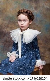 Art Fashion History.Portrait Of A Little Girl Posing In A Blue Dress With A Ruffled Collar Of The Late Renaissance.