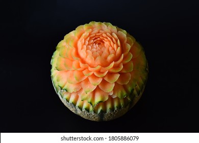 The Art Of Fruits And Vegetable Carving. The Traditional Of Art In Thailand. Sculpture Fruits And Vegetable In To The Beautiful Flowers. Fruit, Melon On Black Background. 