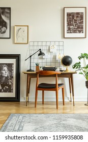 Art Gallery In A Retro Home Office Interior With A Desk And Chair. Real Photo