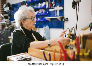 Art Jeweler on tablet computer in studio - Powered by Shutterstock