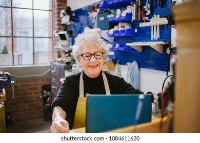 Art Jeweler on tablet computer in studio - Powered by Shutterstock