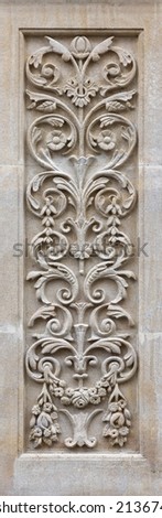 Art nouveau style carved panel on a building exterior. Ornate decorative panel with leaves and flowers. Traditional design in limestone. 