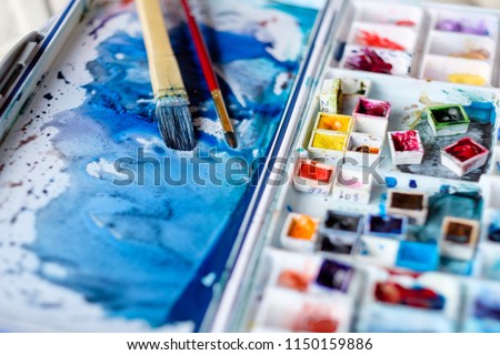 art painting inspiration creativity concept. mixed ink colors. watercolor palette and brushes. artist instruments.