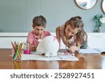 Art, painting and kids at table together for growth, creative development or homeschool for sibling bonding. Fun, craft and children drawing with watercolor, brush and teamwork project in living room