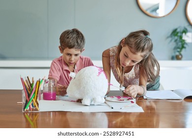 Art, painting and kids at table together for growth, creative development or homeschool for sibling bonding. Fun, craft and children drawing with watercolor, brush and teamwork project in living room - Powered by Shutterstock