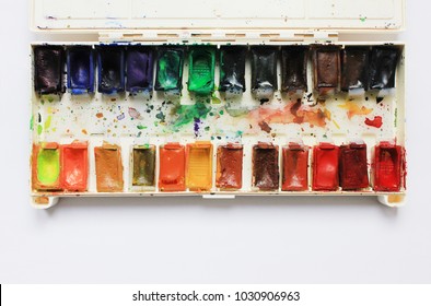 Art Palette with Colorful Paints Close Up Top View. Aquarelle Watercolor Palette at Art Studio with Empty Copy Space. Artist Work Place with Art Supplies, Top View of Art Palette with Various Paints.