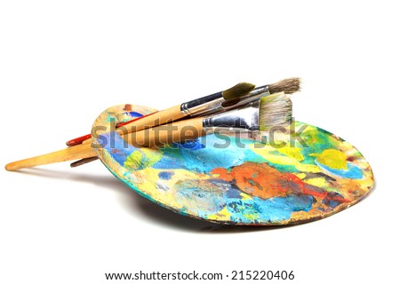 Art palette with paint and a brush on white background 