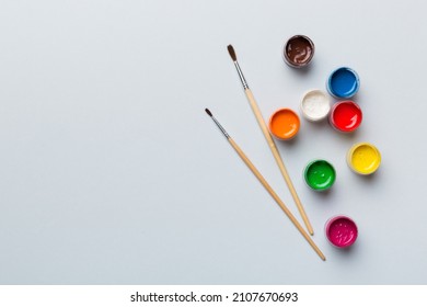art palette with paint and brushes, close up. Top view with empty space. workplace for creativity. home teaching concept drawing. - Powered by Shutterstock