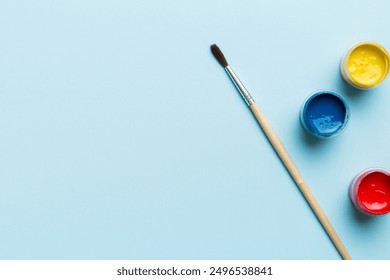 art palette with paint and brushes, close up. Top view with empty space. workplace for creativity. home teaching concept drawing. - Powered by Shutterstock