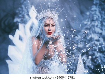 Art photo Fantasy woman snow queen blows on sparkles glitter sparkles cold creating magic in forest, white dress crown icicles. Fairy tale girl frozen princess lady Winter nature forest trees ice fog