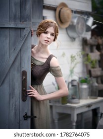 Art Photo Of A Gentle Girl With Braided Hair Outside The Barn Door