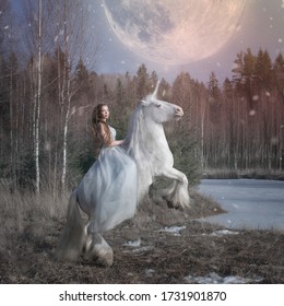 Art photo of the ice queen riding on a snow-white unicorn on the shore of a frozen lake