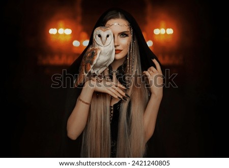 Art Photo real person fantasy gothic mystical woman holding white barn owl in hand, hiding part of face. Fantasy Elf Blonde hair sorceress girl beautiful eyes lips looking into camera Wild bird wings.