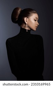 Art portrait woman in black turtleneck. Hair high beam, perfect profile face. Elegant beauty style. Earrings in the ears - Shutterstock ID 2310169965