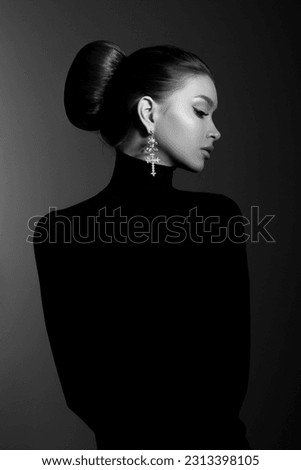 Art portrait woman in black turtleneck. Hair high beam, perfect profile face. Elegant beauty style. Earrings in the ears