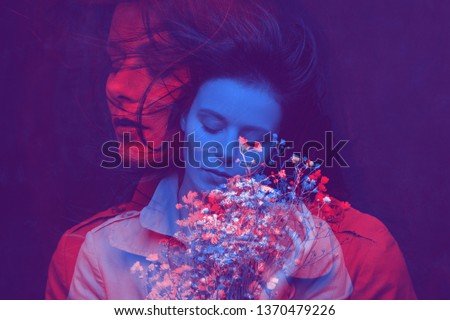 Art portrait of a young pretty woman. Color double exposure.