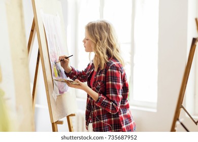 Art School, Creativity And People Concept - Student Girl Or Artist With Easel, Palette And Paint Brush Painting Still Life Picture At Studio