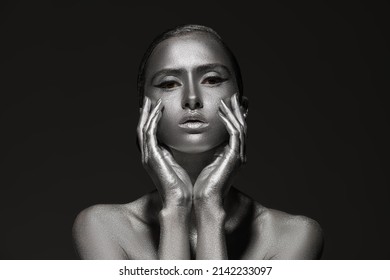 Art Shot Of A Beautiful Model Girl With Metallic Silver Skin. Glittering Makeup. Body Painting, Body Art. Beauty And Cosmetics Concept. 