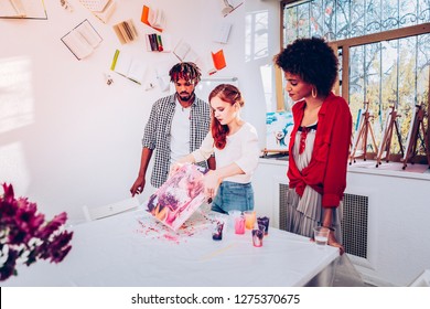 Art Student. Young Art Student Wearing Beige Shirt Giving Master Class In Marble Painting