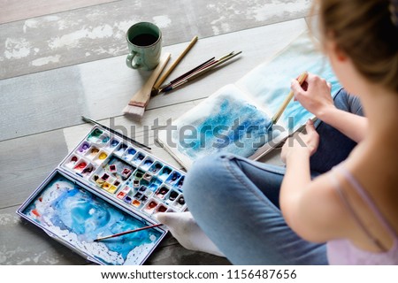 art therapy. painting classes or courses. creativity inspiration expression concept. woman drawing abstract blue painting.
