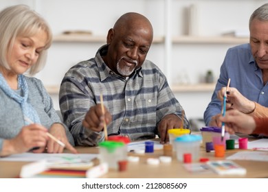 Art Therapy For Seniors Concept. Happy Multiracial Elderly Men And Women Enjoying Painting With Brush, Having Conversation And Smiling, Attending Drawing Master-class Together