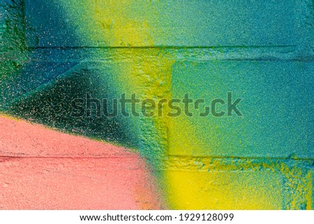 Art under ground. Beautiful street art graffiti background. The brick wall is decorated with abstract drawings house paint. Modern style urban culture of street youth. Abstract picture on wall