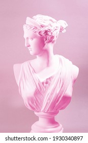 Artemis, A Pink Statue With A Purple Background