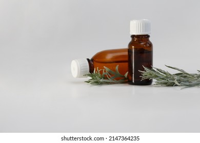 artemisia vulgaris, absinthium essential oil bottle with artemisia vulgaris fresh leaves isolated white