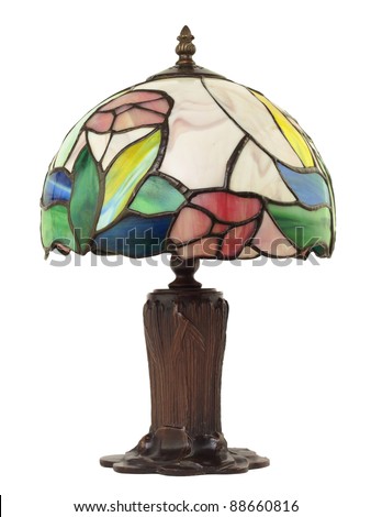 Artful, beautiful little stained glass lamp with a brass base on white