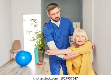 Arthritis Of An Elbow Joint In A Senior Woman Patient In A Rehabilitation Center. Chiropractor Helps Perform Hand Health Recovery Exercises