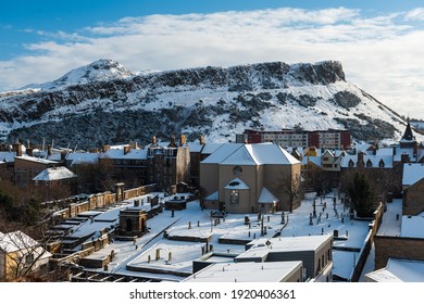 Arthurs Seat Wide Shot With Canongate Kirkyard In The Foreground, All Covered In Snow In Edinburgh