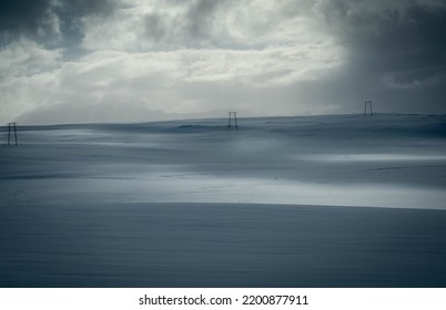 artic islandic icy landscape with electric poles in the distance