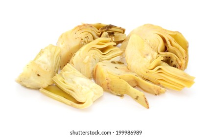 Artichoke heart segments in olive oil and herbs, isolated on a white background
