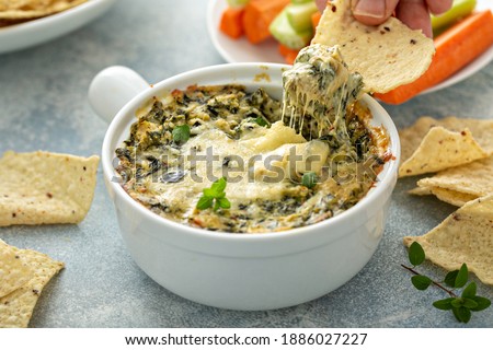 Artichoke spinach dip in a baking dish with a cheese pull Stockfoto © 