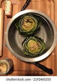 Artichokes In Steamer Basket With Garlic