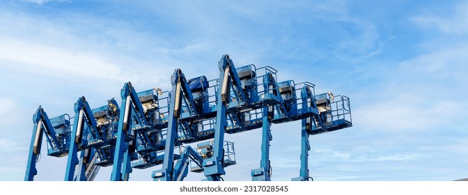 Articulated boom lift. Aerial platform lift. Telescopic boom lift against clear sky. Mobile construction crane for rent and sale. Maintenance and repair hydraulic boom lift service. Crane dealership.