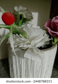 artificial bookay with red balls and white and pink flowers 