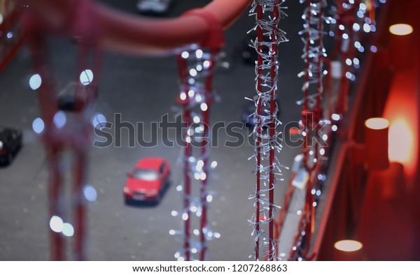 Artificial bridge\
of toy cars with bokeh lights.\
