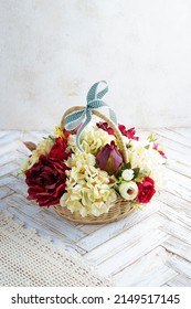 artificial flower look like real flowers. fake mixed yellow adn maroon flower in rattan vas.
clean white background 
