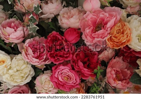 artificial flowers, floral carpet. Pink artificial roses background. Soft lighting.