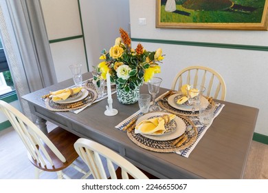 Artificial flowers on the dining table. Cottage plate setting with yellow handkerchief on wood table. Home decoration with beautiful flower. - Powered by Shutterstock