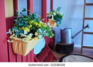 Artificial flowers in a vase. Decor for a bright children's room in the garden style.
