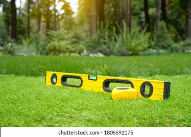 Artificial Grass Installation Background With Measurement Tools And Artificial Turf At The Yard